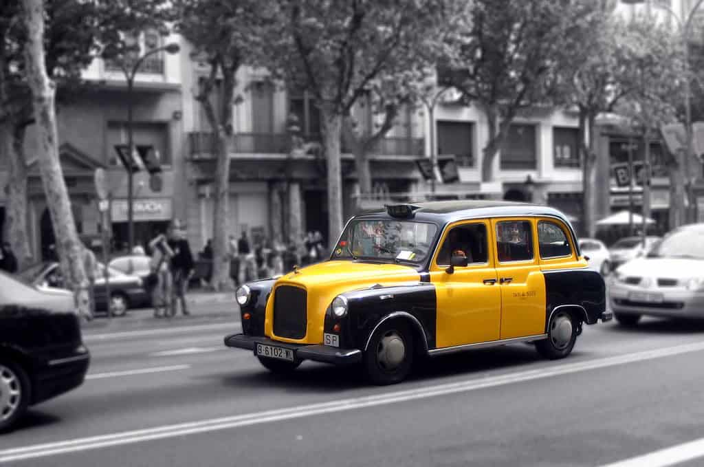 Official black and yellow taxi on a street in Barcelona