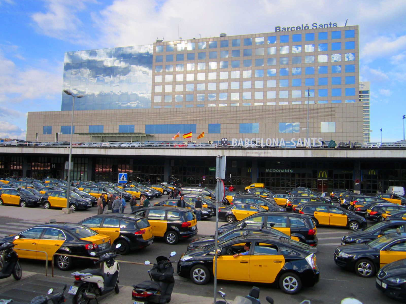 Barcelona-Sants train station exterior with a rank of taxis, the hub for most day trips from Barcelona