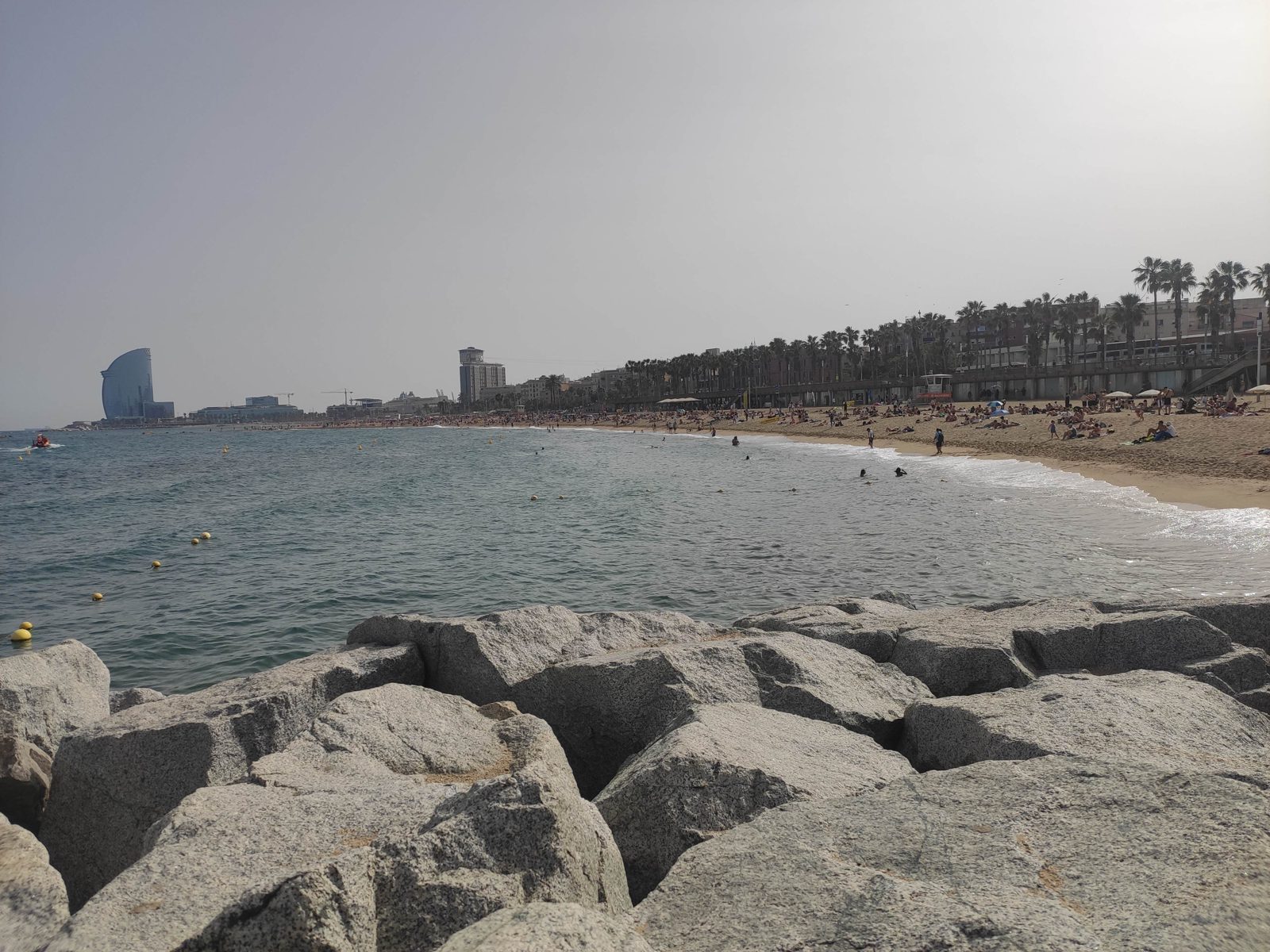 Barceloneta beach in Barcelona with people and the city skyline